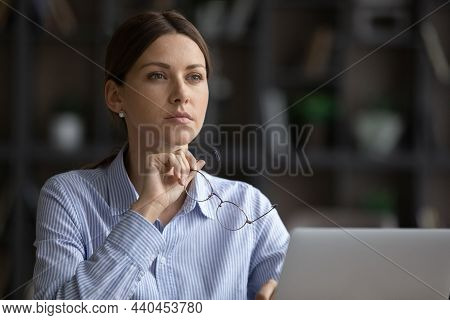 Pensive Serious Businesswoman Takes Off Glasses Looks Into Distance