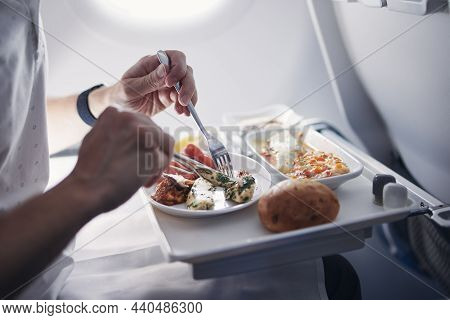 Passenger Eating Airline Meal In Airplane. Menu In Business Class On Medium Haul Flight.