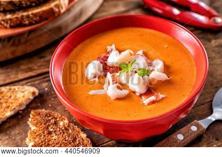 A Bowl Of Delicious Creamy Lobster Bisque With Lobster Meat, Tomato Paste, Cream And Cognac.