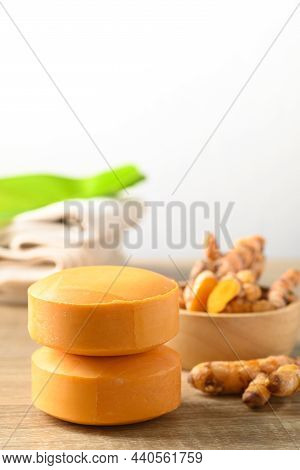 Turmeric Soap And Fresh Turmeric Root In A Bowl On Wooden Table With White Background, Herbal Organi