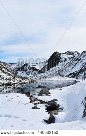 Snowy White Mountains, Snow-capped Top, Stream, River,cloudy Sky.beautiful View In Switzerland, Euro