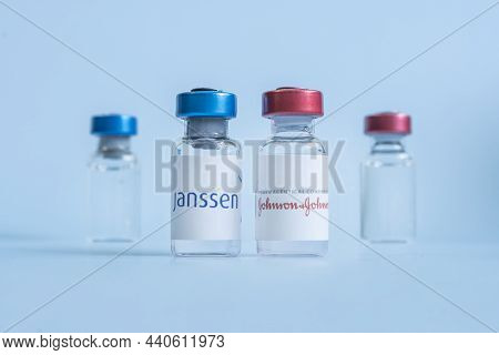 A Vaccination Syringe And A Glass Ampoule With A Clear Liquid On A Blue Background With The Logo Of 