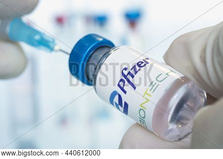 Vials Of Liquid The Logos Pfizer And Biontech In The Doctors Hand