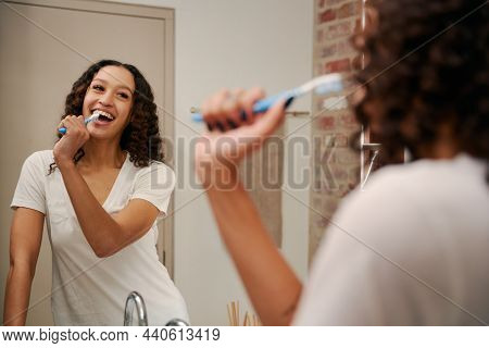 Healthy Multi-cultural Young Female Singing Into Toothbrush As A Microphone In Bathroom. Happy, Danc