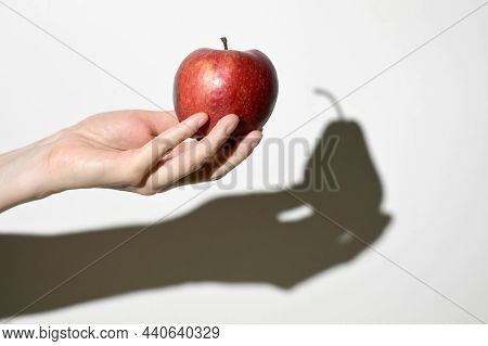 Visual Dissonance Concept. Apple Fruit And Pear Fruit Shadow