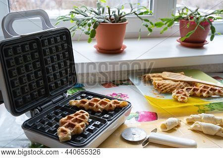 Croffles Are Waffles Made Of Puff Pastry, Baked In An Electric Waffle Iron. Next To The Raw Dough Bl