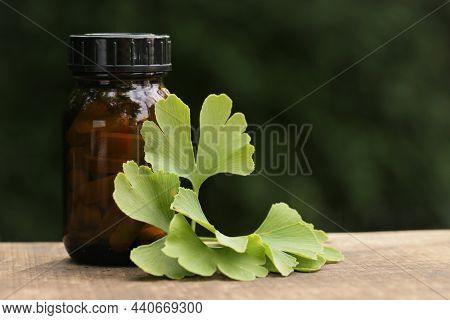 Ginkgo Biloba Tablets.alternative Medicine And Homeopathy. Brown Jar With Pills , Ginkgo Biloba Leav