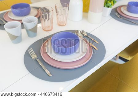 Yellow Chair And Table With Pink Pastel Plate Setting On Dinning Table Of Modern Home.