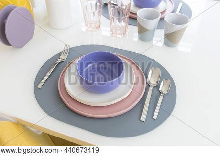 Yellow Chair And Table With Pink Pastel Plate Setting On Dinning Table Of Modern Home.