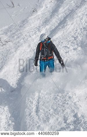 VALMOREL, FRANCE - CIRCA, 2019: Snowboarder in deep snow free ride coming down the slope after heavy snowfall in Valmore, French Alps