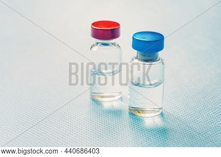Medicine In Bottles With Red And Blue Capsule. On Blue Background. Copy Space.