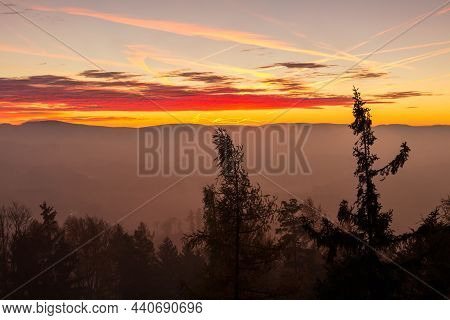 Autumn Czech Landscape With Misty Fog And Trees Silhouette Before Morning Sunrise. View From Watchto