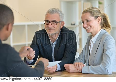 couple signing contract with real estate agent