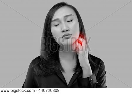 Asian Woman Scratched Her Neck On A Gray Background.