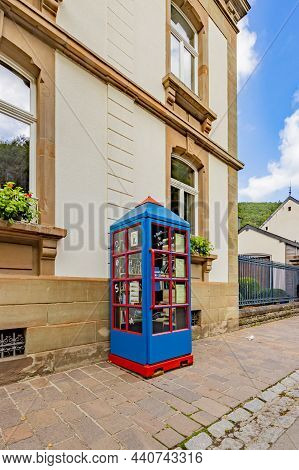 Esch-sur-sûre, September 21th 2021. Small Public Library Or Intellectual Booth On The Sidewalk Next 