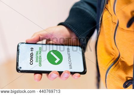 Covid-19 Green Pass, Detail Of A Hand With A Mobile Phone With The Health Passport. Vaccination Cert