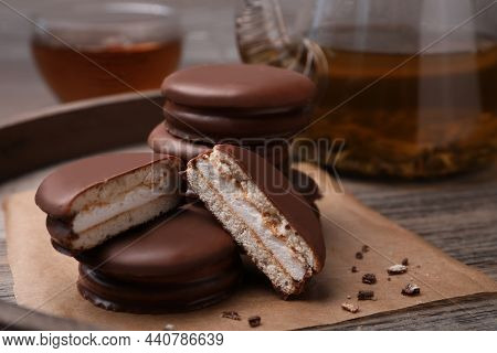 Tasty Choco Pies And Tea On Wooden Tray, Closeup View