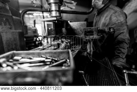 Milling Machine Working Near Worker With A Protective Mask. Tool For Cut Metal Workpiece. Vertical M