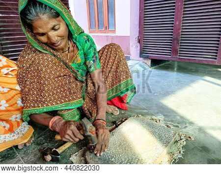 Lucknow, India, October 2021 : A Rural Woman Repair Traditional Spices Maker Sil Batta