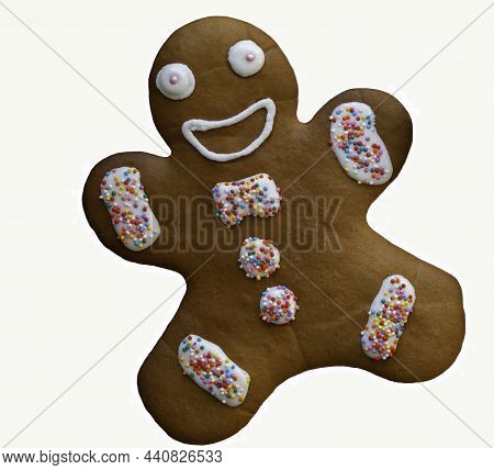 Isolated Brown Gingerbread Man Glazed With Icing And Decorated With Colorful Balls On White Backgrou