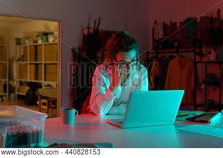 Young Female Fashion Designer Work On Laptop In Studio Answering Business Email And Making Orders On