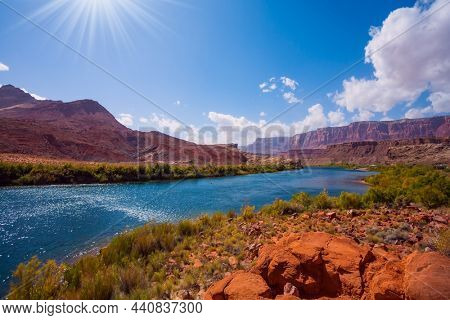 Lee's  Ferry is a historic boat ferry across the Colorado River. Amazing wildlife. USA. Wide river and shores of red sandstone. Bright and hot sunny day. The concept of extreme and photo tourism