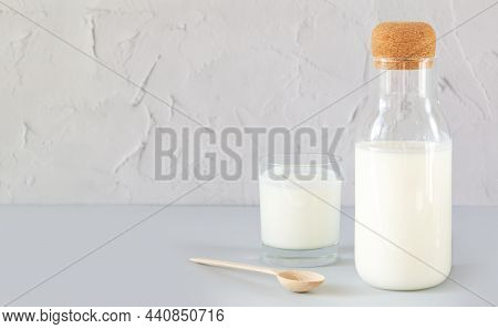 Vintage Jar With Cork Of Homemade Yogurt, Kefir, Fermented Milk Or Sour Cream Next To Drinking Glass