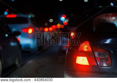 Close-up View Of Car Tail Light And Right Turn Signal At Night Traffic Jam With Selective Focus And 