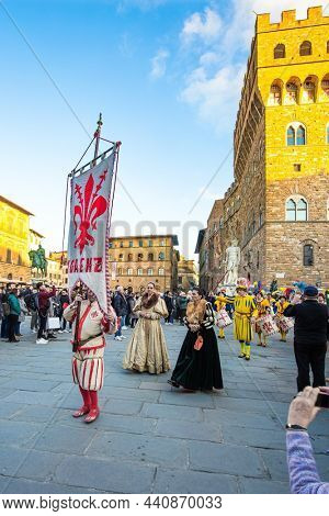FLORENCE, ITALY - NOVEMBER 30, 2019: Fancy-dress ball in the Signoria square. Carnival participants and enthusiastic spectators. Great costumes and equipment of the participants