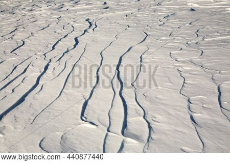 Elongated Ridges Of Snow Across The Wind. Landform Background