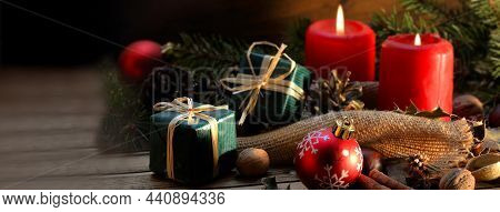 Traditional Christmas Decoration On A Wooden Table With Gifts, Canddles