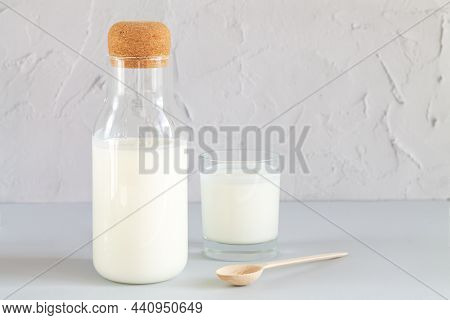 Vintage Jar With Cork Of Homemade Yogurt, Kefir, Fermented Milk Or Sour Cream Next To Drinking Glass