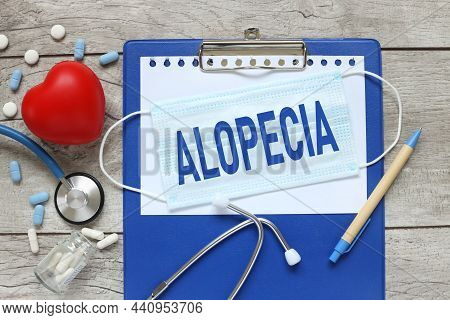 Alopecia. Stethoscope With Notepad, Red Heart And Pen On Blue Wooden Table
