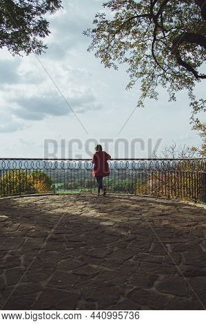 Young Woman Standing In Beautiful Park In The City Of Przemysl On A Sunny Clear Day Against A Bright