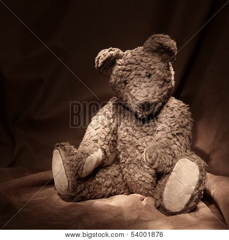 Teddy bear on brown background