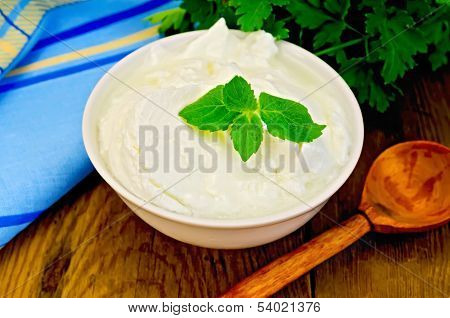 Yogurt In A White Bowl With A Wooden Spoon