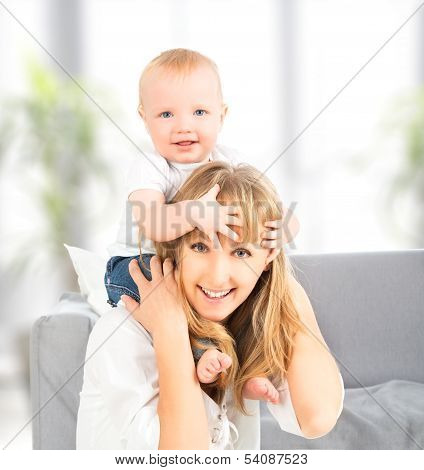 Happy Family. Baby Sits Astride The Shoulders Of The Mother