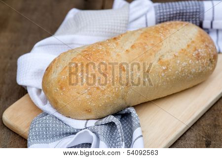 Loaf Of Sourdough Bread In Rustic Kitchend Setting