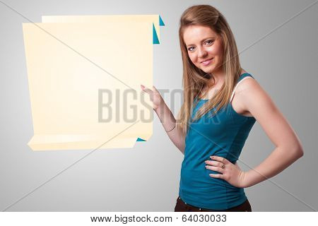 Baeutiful young woman holding white origami paper copy space