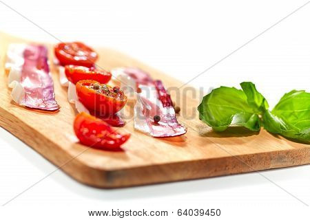 Light Snack. Dried Tomatoes And Bacon Served On Board. Selective Focus.