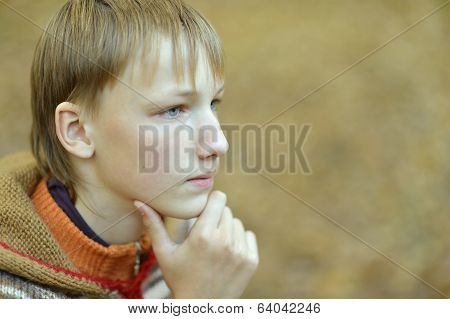 Sad little boy outdoors