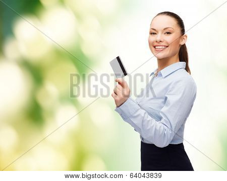 business and bank concept - smiling businesswoman showing credit card