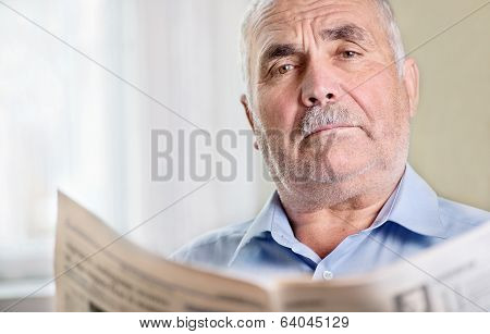 Senior Man Relaxing Reading A Newspaper