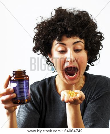 Woman holds pills in her palm