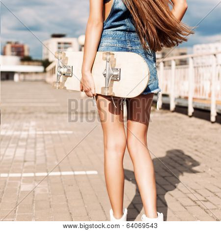 Beautiful Lady With Long Silky Hair In Denim Short Overalls