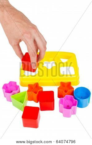 Human Hand Puts Wrong Shape Into Shape Sorter Toy Isolated