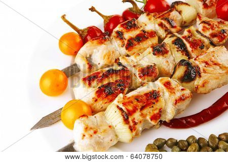 fresh turkey barbecue shish kebab served with tomatoes capers on platter isolated over white background