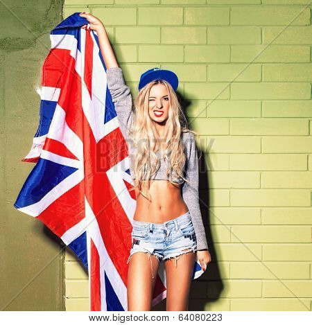 Sexy Suntan Girl In Short Jeans Shorts Against Green Brick Wall