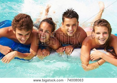 Group Of Teenage Friends Having Fun In Swimming Pool