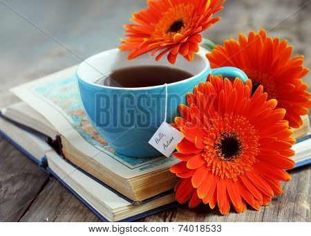 A Cup Of Tea With Gerbera Flowers And Books